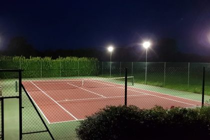 Mounted LED flood lights offer energy efficient illumination to a tennis court in Faversham, Kent 